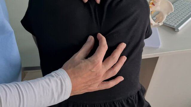 Orthopedist examining child's back in clinic, closeup. Scoliosis treatment
