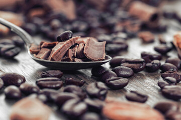 Broken dark chocolate and coffee beans on a table