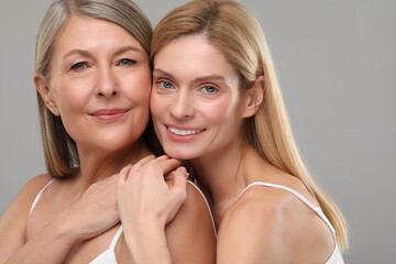 Beautiful women with healthy skin on gray background