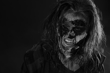 Scary zombie on dark background, black and white effect. Halloween monster