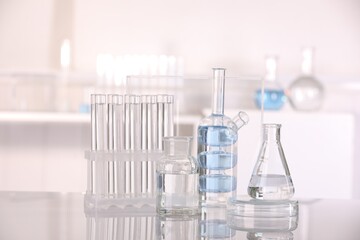 Laboratory analysis. Different glassware with liquid on white table indoors