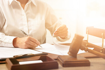 Lawyer working with document at table in office, closeup
