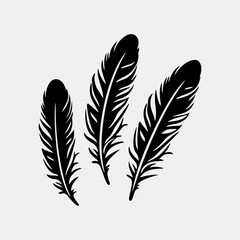 three black feathers on a white background