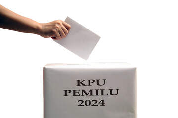 Indonesian election day, hand inserts ballot paper into ballot box which says KPU election 2024.