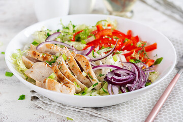 Fresh  salad  with grilled chicken breast, fillet and lettuce, daikon, red onions, cucumber and sesame. Healthy lunch menu. Diet food.