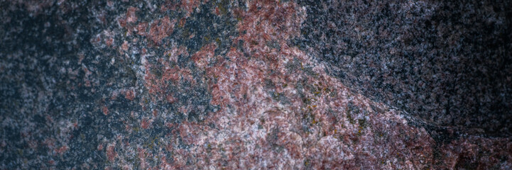 Red granite texture. A variegated, spotted background of red with dark gray rough granite. The...