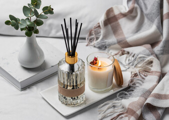 Obraz na płótnie Canvas Aromatic reed air freshener, eucalyptus leaves and candle