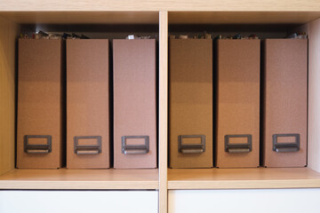 Filling the office cabinet with folders with documents, arranging files