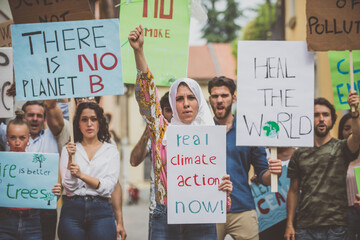 Public demonstration on the street against global warming and pollution. Group of multiethnic...
