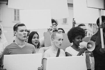 Public demonstration on the street against social problems and human rights. Group of multiethnic...