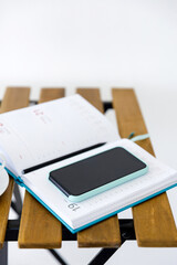 smartphone and notepad for planning affairs lie on table