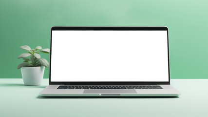 A laptop with blank white screen for mock up and potted houseplant on a light mint background