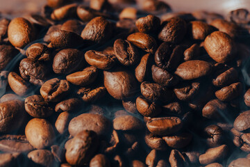 Roasted coffee beans with smoke and fire background. Close up