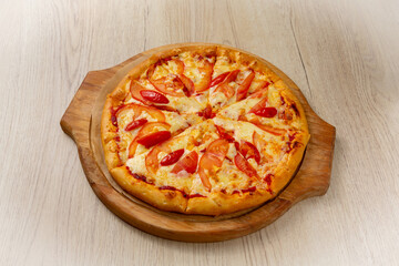 Pizza margherita. On a light wooden background.