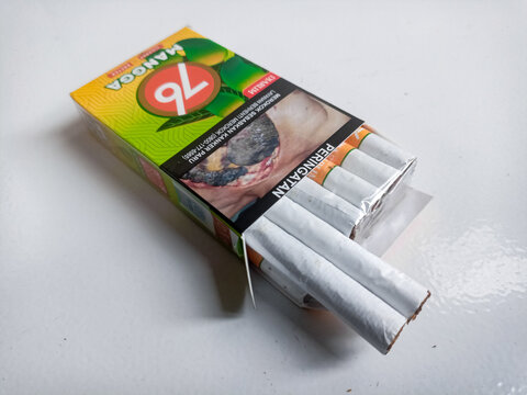 Djarum 76 Mangga Kretek up close. Packaged cigarettes. Djarum 76 mangga Kretek cigarettes on isolated background. Bandung-Indonesia,1-28-2024