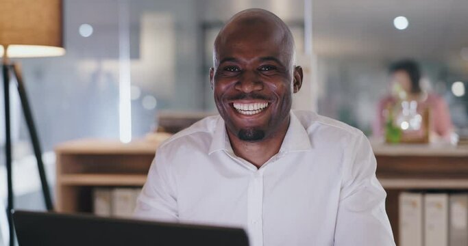 Businessman, happy and face by laptop in office, professional and technology in confidence at work. African man, portrait or positive in career as entrepreneur, files or smile in startup by computer