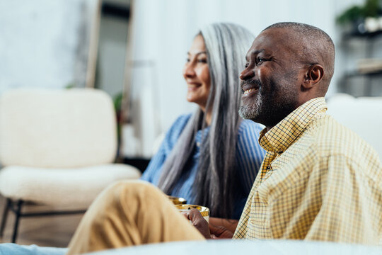 cinematic image of a multiethnic senior couple.