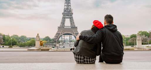 cheerful happy couple in love visiting Paris city centre and Eiffel Tower