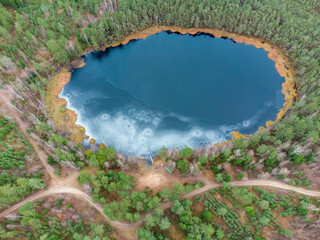 Aerial view of the lake in Lithuanian forests, winter, wild nature. Name of the lake "Vilkinis", Varena district, Europe.