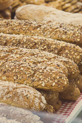 Freshly baked wholegrain baguette with grains in bakery
