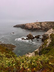 Lighthouse on the rocky coast of the ocean, ocean lighthouse, rocky coast