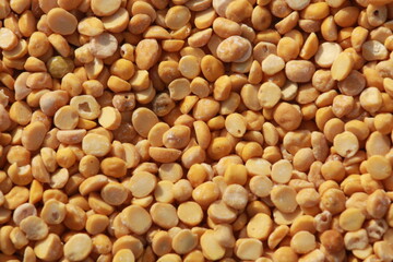 Close up of tuwar daal or yellow dried pea background. Pile of Indian famous pulse or pea. 