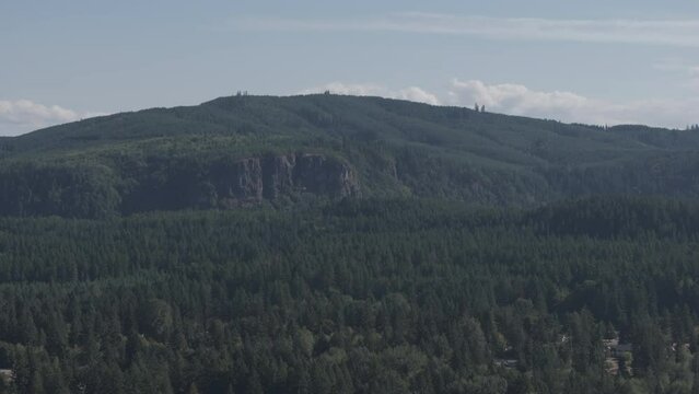 Ungraded 4k aerial drone footage of a mountain and forest on a sunny and hazy day near Eatonville, Washington.