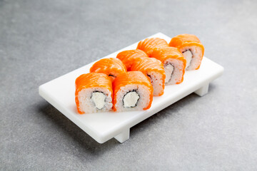 Japanese Sushi roll Philadelphia classic on a white stand, gray background