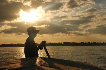 Boat driver on Mekong River during Sunset (Kratié, Cambodia)