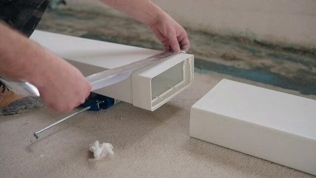 Professional installation of flat plastic ventilation ducts for kitchen hoods. Sealed gluing of plastic pipes with with aluminum tape