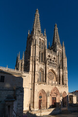 Fototapeta na wymiar Gothic cathedral facade of the city of Burgos at sunset in a suuny day. Castilla y Leon, Spain.