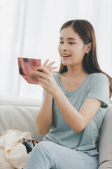 woman makes make-up, applies powder with a brush. Self-care, skin care, natural authentic beauty. Treat yourself. beautiful Asian lady getting ready applying make-up myself