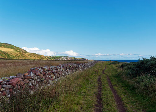 The Coastal Footpath between Johnshaven and Inverbervie on the East Coast of Scotland in Aberdeenshire, with the Fishing Village of Gourdon in the distance.