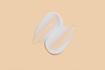 cosmetic smear cream texture on beige background. Sample facial cream