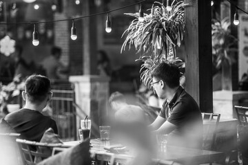 black and white Midsection of man pouring milk in coffee at café.
Midsection of male owner pouring...