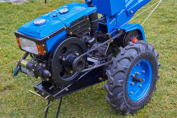 Obraz premium walk behind tractor for the farmer, new two-wheeled tractor for working in the field, equipment for the farmer