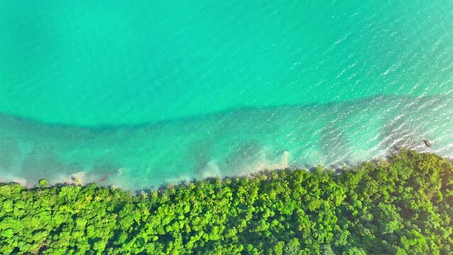 Lush coastal rainforests, mountains, and turquoise waters paint a tropical paradise from above. Nature's beauty captured by drone. World destination concept. Cinematic footage. Ko Chang, Thailand. 
