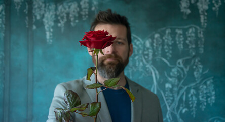 handsome man with red rose. valentines day concept, mother day, women day