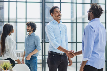 Successful Business Collaboration: Executives Greet with Handshake in Office