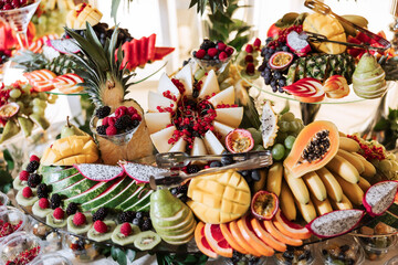 Fruit buffet for a wedding. Assortment of exotic fruits in the restaurant. Various compositions from fresh fruits.