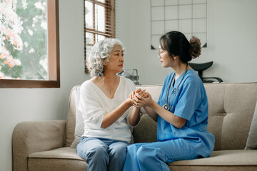 Asian female hands touching old female hand Helping hands take care of the elderly concept.