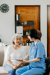 Medical doctor holing senior patient's hands and comforting her.