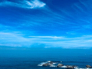 Rocky ocean coast, blue ocean horizon
