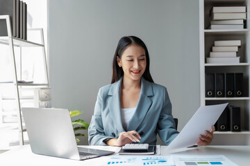 Young happy businesswoman using computer in office, Stylish Beautiful Manager Smiling, Working on Financial and Marketing Projects, Portrait of a young businesswoman working on a laptop in an office