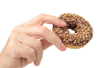 Human hand holding chocolate and crushed nuts donut