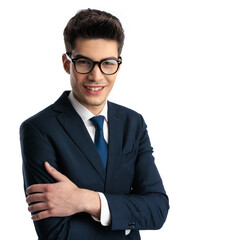 happy young businessman with glasses crossing arms and looking forward