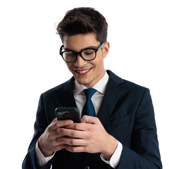 attractive young man with glasses looking at screen and texting