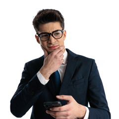 thoughtful businessman with glasses touching chin and thinking