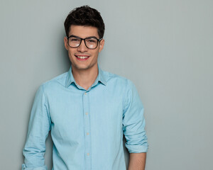 happy casual man with glasses in denim shirt looking forward and smiling