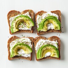 flat lay of traditional english sandwiches on black bread with avacado and cream cheese for breakfast on white background